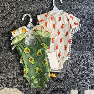 2 sets of 3 pack onesies by Gerber. New with tags. Size newborn and 0-3 months.